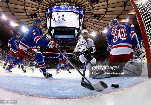 Anton Stralman of the New York Rangers clears the puck from the goalline and Jeff Carter of the Los Angeles Kings during the first period of Game...