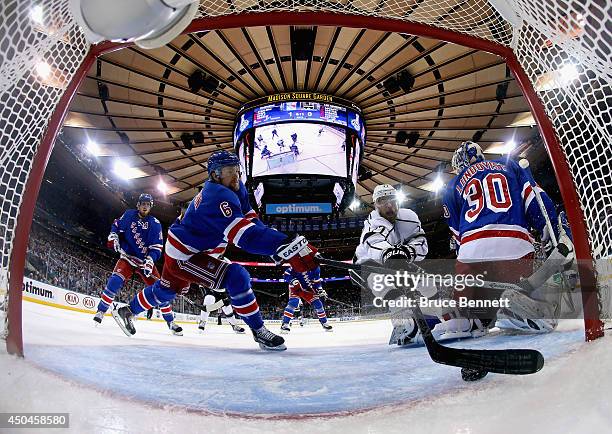 Anton Stralman of the New York Rangers defends the puck from Jeff Carter of the Los Angeles Kings during the first period of Game Four of the 2014...