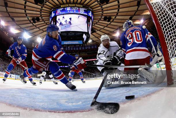 Anton Stralman of the New York Rangers defends the puck from Jeff Carter of the Los Angeles Kings during the first period of Game Four of the 2014...