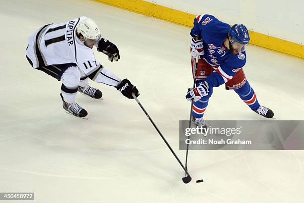 Dominic Moore of the New York Rangers is chased by Anze Kopitar of the Los Angeles Kings in the first period of Game Four of the 2014 Stanley Cup...