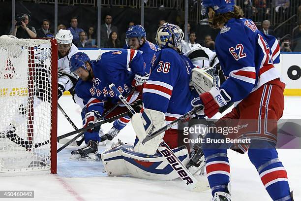 Anton Stralman of the New York Rangers sweeps the puck away from the goalline and Marian Gaborik of the Los Angeles Kings during the first period of...