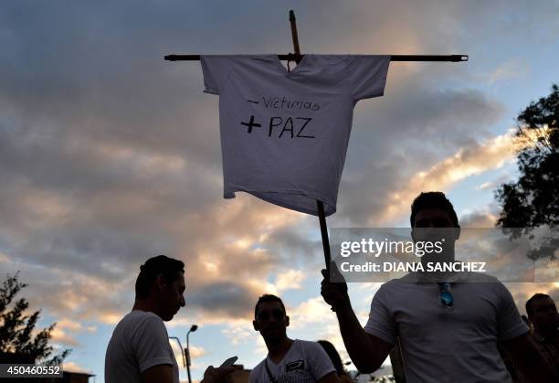 Supporters of Colombian president and presidential candidate Juan Manuel Santos participate in an event in Bogota, on June 11, 2014. Colombia's...