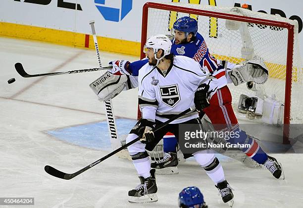 Derick Brassard of the New York Rangers reaches for the puck behind Drew Doughty of the Los Angeles Kings in the third period of Game Four of the...