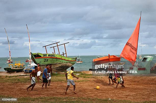 Kids play football on the beach as Brazil prepares for World Cup on June 11, 2014 in Maceio, Brazil.