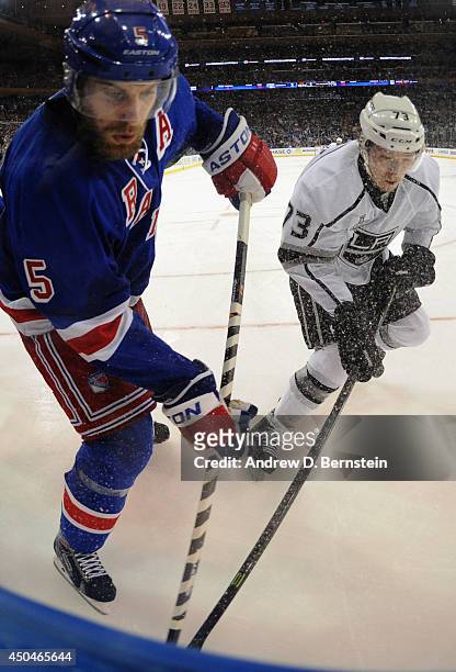 Tyler Toffoli of the Los Angeles Kings and Dan Girardi of the New York Rangers battle for the puck in the third period of Game Four of the 2014...