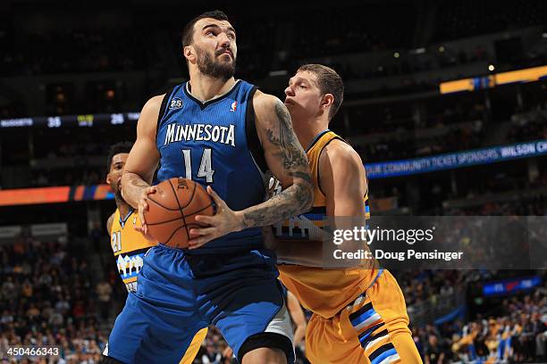 Nikola Pekovic of the Minnesota Timberwolves controls the ball as Timofey Mozgov of the Denver Nuggets plays defense at Pepsi Center on November 15,...