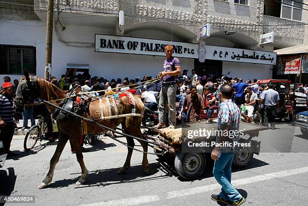 Employees of the Palestinian National Authority withdrawing cash from an Automated Teller Machine in Rafah in the southern Gaza Strip. Palestinian...