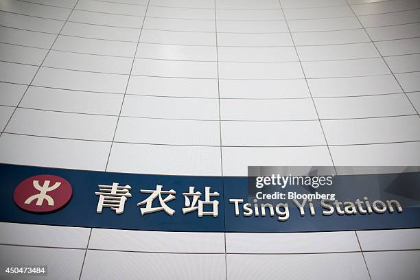 The MTR Corp. Logo is displayed next to a sign for Tsing Yi station in Hong Kong, China, on Thursday, June 12, 2014. MTR provides public transport...