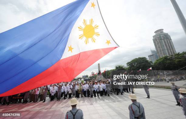 The Philippines national flag is raised in Manila on June 12, 2014 as the Southeast Asian archipelago celebrates the 116th anniversary of its...