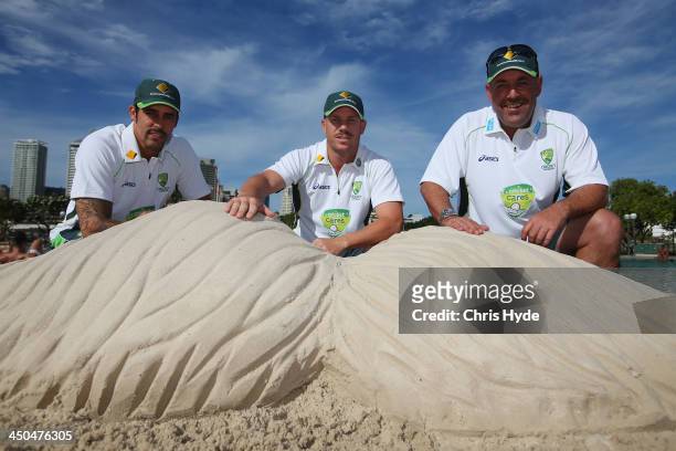 Australian Cricket players Mitchell Johnson and David Warner and Australian coach Darren Lehman pose with the sand Mo at Southbank during the Cricket...