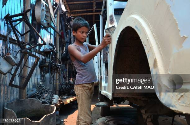 Eleven year-old Indian boy, Mohammad Abdul Salem works on a car at a vehicle repair garage on World Day Against Child Labour in Dimapur, in...