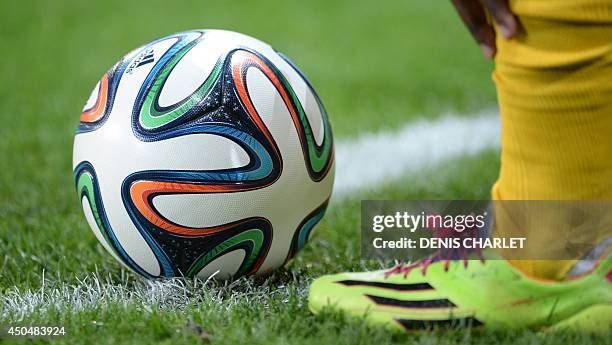 Jamaica national football team player stands next to a Brazuca official ball of the 2014 FIFA World Cup during a friendly football match between...