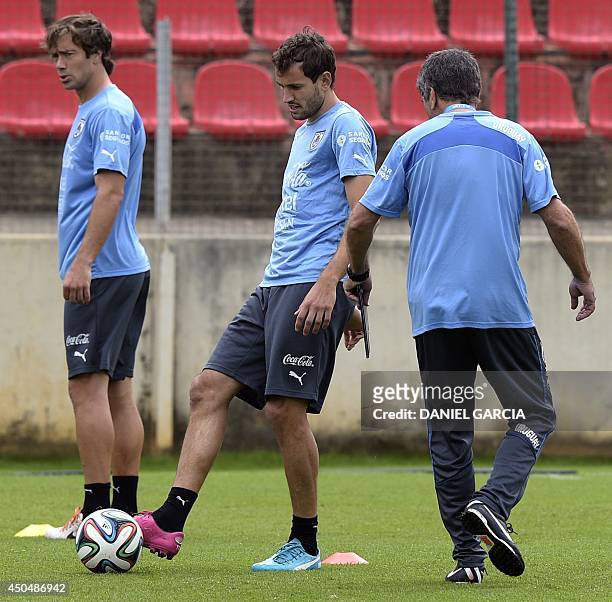 Uruguay's forward Cristhian Stuani kicks the ball next to defender Diego Lugano during a training session at Arena do Jacare training site in Sete...