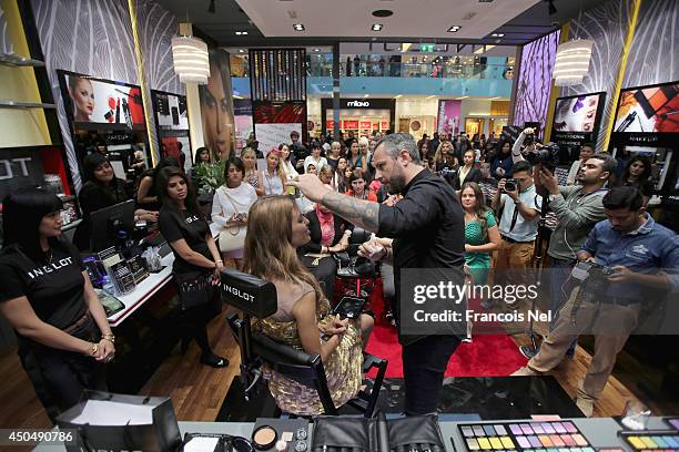 Jon Hennessey,celebrity makeup artist gives Victoria Bonya a makeover during the Inglot shop opening at Dubai Mall on June 12, 2014 in Dubai, United...