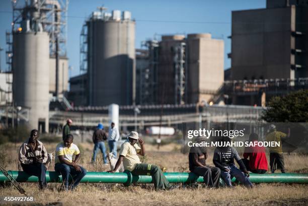 Striking platinum miners gather at the Wonderkop Stadium in Marikana waiting to receive news on an ending strike proposed deal on June 12, 2014 in...