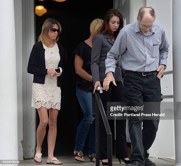 Susan Johnson, left, mother of Derrick Thompson, leaves York County Superior Court in Alfred with family and friends after James Pak entered an...