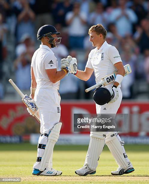 Joe Root of England celebrates with teammate Matt Prior after reaching his century during day one of the 1st Investec Test match between England and...