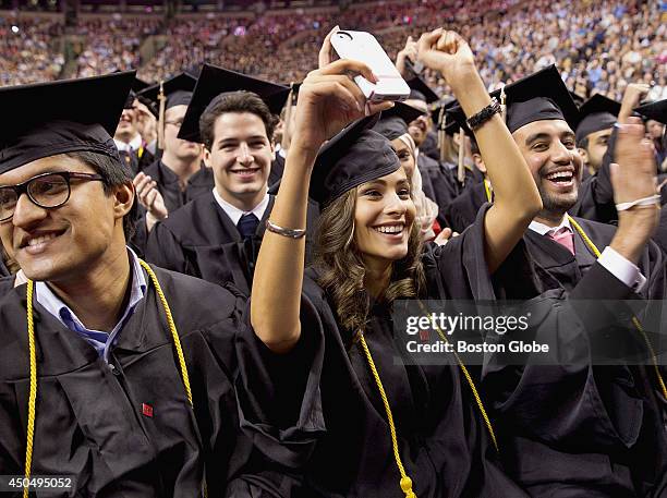 Left to right, Pathros Alex , Rana Al Alawi and Khalid Al Dabal celebrate during Northeastern University's commencement exercises at TD Bank Garden...