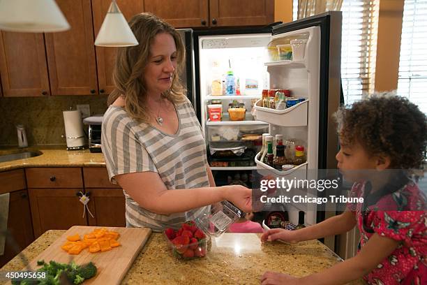 Jennifer Leigh, with her daughter Janelle at home in Evanston, Ill., has lost her sense of smell and has adapted to daily tasks such as cooking by...