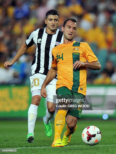 Ivan Franjic of Australia clears the ball in front of Diego Calvo from Costa Rica during their friendly football match in Sydney on November 19,...