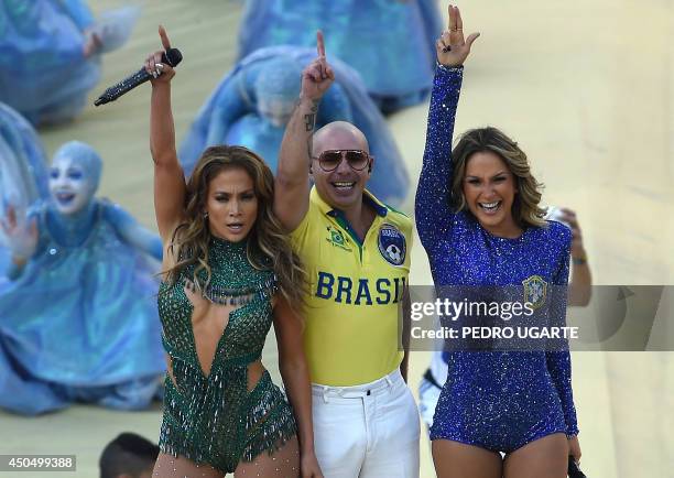 Rapper Pitbull Brazilian pop singer Claudia Leitte and US singer Jennifer Lopez salute the audience as they take part in the opening ceremony of the...