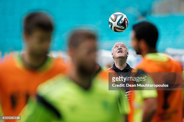 Head Coach, Vicente del Bosque juggles the ball on his head as the players warm up during the Spain training session ahead of the 2014 FIFA World Cup...