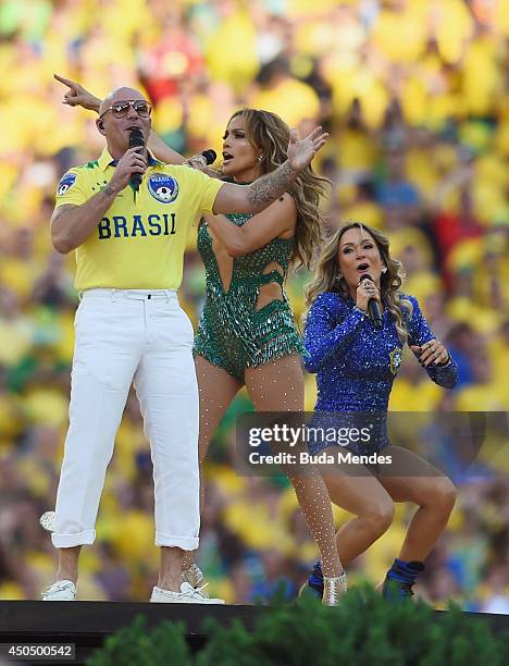 Performers Pitbull, Jennifer Lopez and Claudia Leitte perform during the Opening Ceremony of the 2014 FIFA World Cup Brazil prior to the Group A...