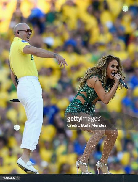 Singers Pitbull and Jennifer Lopez perform during the Opening Ceremony of the 2014 FIFA World Cup Brazil prior to the Group A match between Brazil...