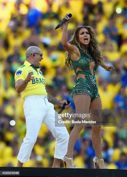 Singers Pitbull and Jennifer Lopez perform during the Opening Ceremony of the 2014 FIFA World Cup Brazil prior to the Group A match between Brazil...