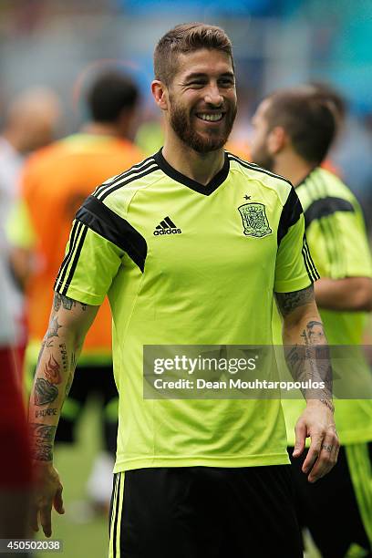 Sergio Ramos laughs during the Spain training session ahead of the 2014 FIFA World Cup Group B match between Spain and the Netherlands held at the...