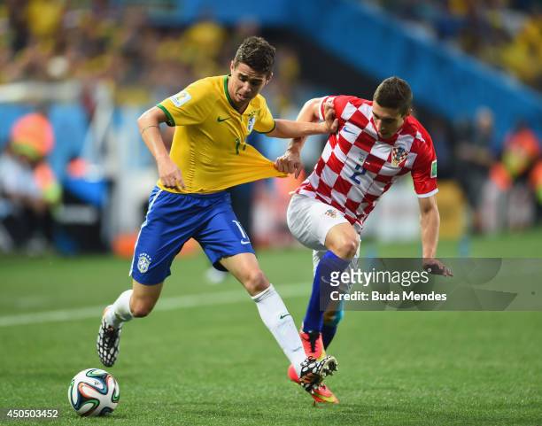 Oscar of Brazil fights off Sime Vrsaljko of Croatia in the first half during the 2014 FIFA World Cup Brazil Group A match between Brazil and Croatia...