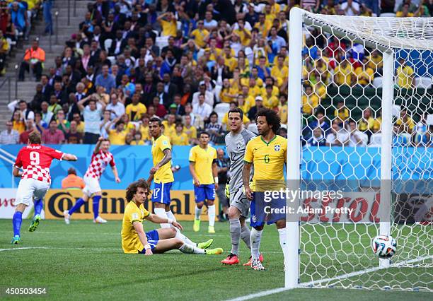 David Luiz, Julio Cesar and Marcelo of Brazil look on after allowing a first half goal during the 2014 FIFA World Cup Brazil Group A match between...