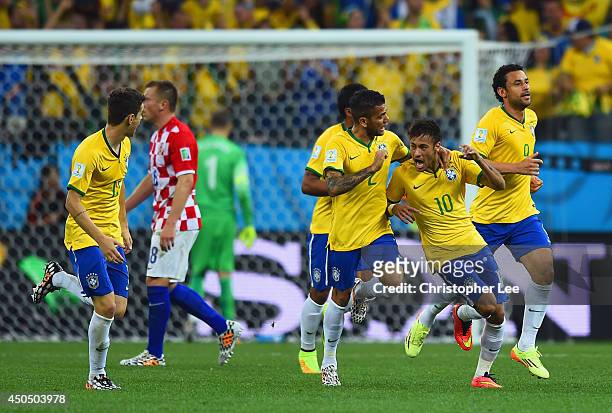 Neymar of Brazil celebrates with Dani Alves and Fred after a goal in the first half during the 2014 FIFA World Cup Brazil Group A match between...