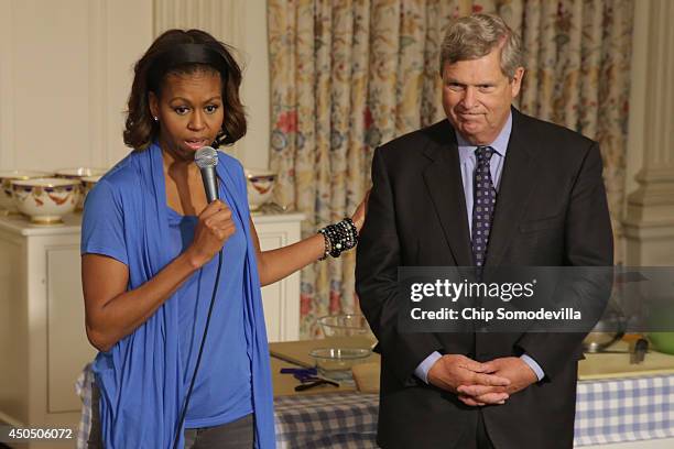 First lady Michelle Obama delivers remarks in the State Dining Room with Agriculture Secretary Tom Vilsack before helping students from five District...