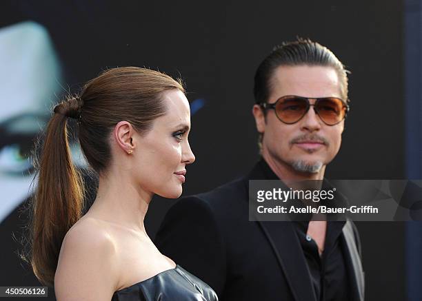 Actors Angelina Jolie and Brad Pitt arrive at the World Premiere of Disney's 'Maleficent' at the El Capitan Theatre on May 28, 2014 in Hollywood,...