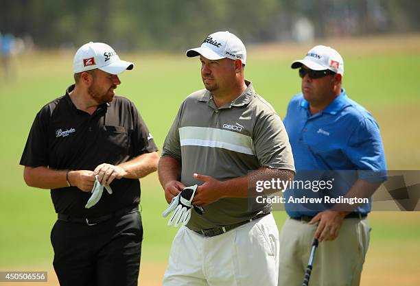 Shane Lowry of Ireland , Brendon de Jonge of Zimbabwe and Kevin Stadler of the United States wait together during the first round of the 114th U.S....