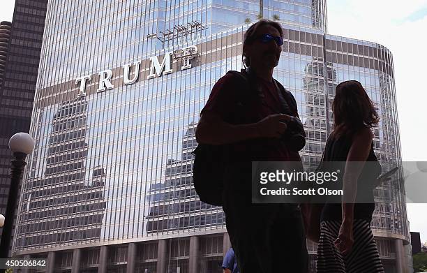 Workers install the final letter for a giant TRUMP sign on the outside of the Trump Tower on June 12, 2014 in Chicago, Illinois. Many in the city are...