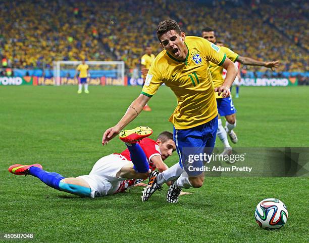 Oscar of Brazil is tripped up by Sime Vrsaljko of Croatia in the second half during the 2014 FIFA World Cup Brazil Group A match between Brazil and...