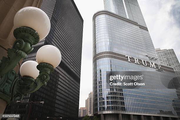 Workers install the final letter for a giant TRUMP sign on the outside of the Trump Tower on June 12, 2014 in Chicago, Illinois. Many in the city are...