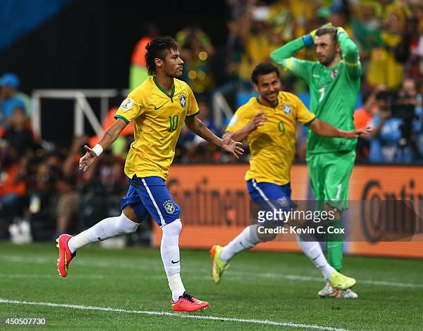 Neymar of Brazil celebrates after scoring his second goal with Fred as Stipe Pletikosa of Croatia looks on during the 2014 FIFA World Cup Brazil...