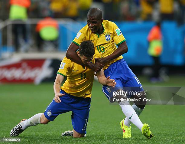 Ramires of Brazil pulls Oscar to the ground in celebration after his goal in the second half during the 2014 FIFA World Cup Brazil Group A match...