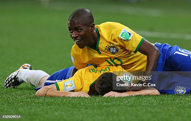 Ramires of Brazil pulls Oscar to the ground in celebration after his goal in the second half during the 2014 FIFA World Cup Brazil Group A match...