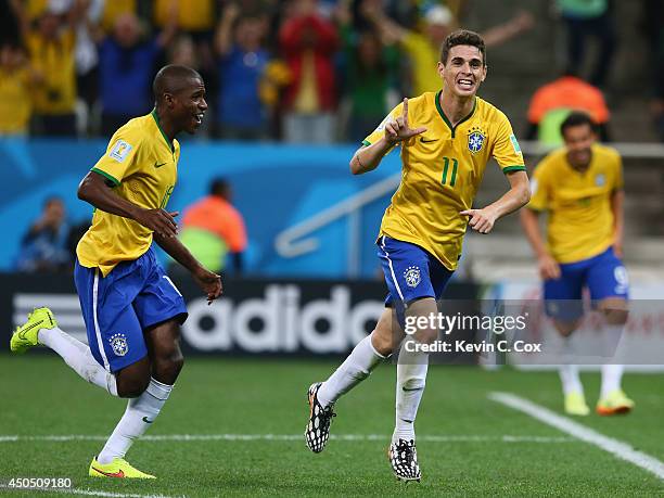 Oscar of Brazil celebrates his second half goal with Ramires during the 2014 FIFA World Cup Brazil Group A match between Brazil and Croatia at Arena...