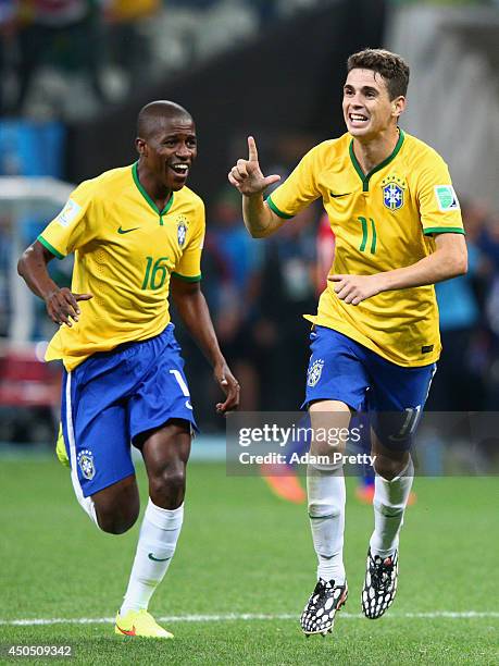 Oscar of Brazil celebrates his second half goal with Ramires during the 2014 FIFA World Cup Brazil Group A match between Brazil and Croatia at Arena...
