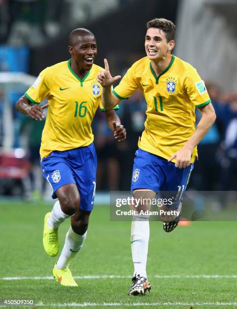 Oscar of Brazil celebrates his second half goal with Ramires during the 2014 FIFA World Cup Brazil Group A match between Brazil and Croatia at Arena...