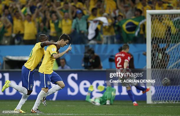 Brazil's midfielder Oscar celebrates scoring the 3-1 goal with Brazil's midfielder Ramires during a Group A football match between Brazil and Croatia...