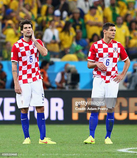 Vedran Corluka and Dejan Lovren of Croatia look on after being defeated during the 2014 FIFA World Cup Brazil Group A match between Brazil and...