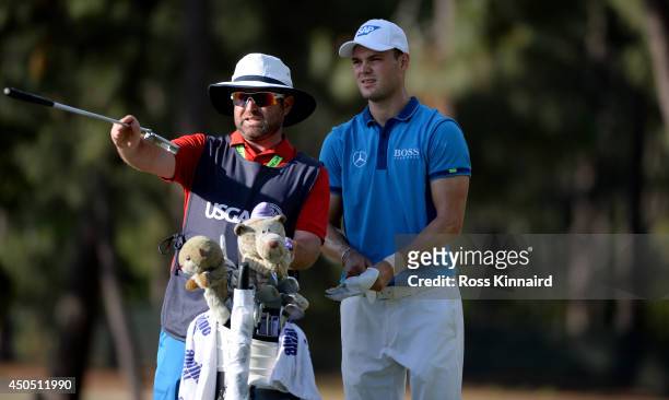 Martin Kaymer of Germany chats with his caddie Craig Connelly on the 18th tee during the first round of the 114th U.S. Open at Pinehurst Resort &...
