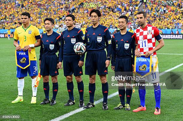Thiago Silva of Brazil and Darijo Srna of Croatia line up with the match officials ahead of the 2014 FIFA World Cup Brazil Group A match between...