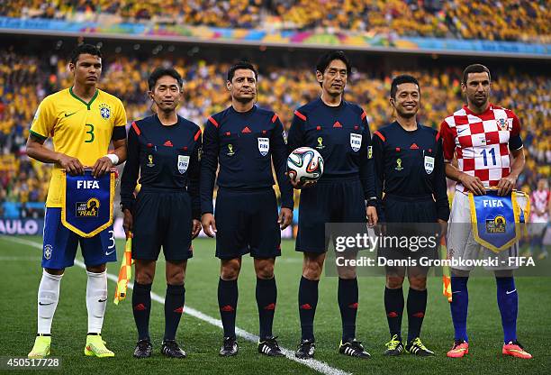 Brazil captain Thiago Silva, referees Toshiyuki Nagi, Alireza Faghani, Yuichi Nishimura, Toru Sagara and Croatia captain Darijo Srna pose for...